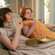 Claudia Jessie and Nicola Coughlan sitting next to one another in Bridgerton Season 1